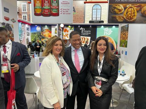 Administrator Daniel B. Whitley, positioned at the center, poses with exhibitors from the California Department of Food and Agriculture at Gulfood 2025. The group stands in front of a display promoting California-grown agricultural products